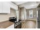 Updated kitchen showcasing stove, countertops, white cabinetry and wood-look flooring at 1106 N Sheffield Ave, Indianapolis, IN 46222