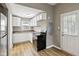 Well-lit kitchen with updated appliances, white cabinetry, and practical layout for cooking convenience at 1106 N Sheffield Ave, Indianapolis, IN 46222
