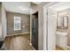 Bright kitchen with stainless steel appliances, wood-look flooring, and a view to the bathroom at 1106 N Sheffield Ave, Indianapolis, IN 46222