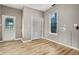 Bright room featuring wood-look flooring, windows and entry to backyard at 1106 N Sheffield Ave, Indianapolis, IN 46222