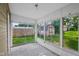 Bright sunroom featuring ample natural light and serene backyard views through large windows at 1106 N Sheffield Ave, Indianapolis, IN 46222
