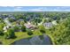 Aerial view of the property showcasing the backyard pond, deck, landscaping, and surrounding lush neighborhood at 11761 Darsley Dr, Fishers, IN 46037
