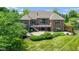 Beautiful backyard with a brick home, spacious deck, stone patio, fire pit, and meticulously maintained landscaping at 11761 Darsley Dr, Fishers, IN 46037