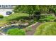 Landscaped backyard with a serene pond, waterfall, and verdant greenery enhances the property's appeal at 11761 Darsley Dr, Fishers, IN 46037