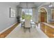 Elegant dining room showcasing a modern chandelier, and a view of the front yard at 11761 Darsley Dr, Fishers, IN 46037