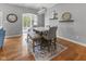Bright dining room with modern chandelier and a marble table with seating for six at 11761 Darsley Dr, Fishers, IN 46037