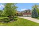 Beautiful home with lush landscaping, a pond, and an attached garage, creating a welcoming and picturesque curb appeal at 11761 Darsley Dr, Fishers, IN 46037