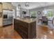 Open kitchen featuring a kitchen island, breakfast bar and stainless steel appliances at 11761 Darsley Dr, Fishers, IN 46037