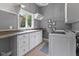 Functional laundry room with white cabinets, utility sink and washer and dryer at 11761 Darsley Dr, Fishers, IN 46037