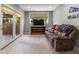 Connected living area with large window, sliding glass door, comfortable seating, and natural lighting at 11761 Darsley Dr, Fishers, IN 46037