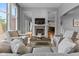 Cozy living room with a fireplace and views into the kitchen, providing a relaxed and inviting atmosphere for gatherings at 11761 Darsley Dr, Fishers, IN 46037