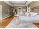 A large bedroom featuring hardwood floors, large bed, and doorway to an en-suite bath at 11761 Darsley Dr, Fishers, IN 46037