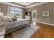 Spacious bedroom with large windows and an ensuite, with a view of the pond at 11761 Darsley Dr, Fishers, IN 46037