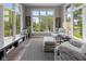 Cozy sunroom with multiple windows, custom window seat and view of the backyard pond at 11761 Darsley Dr, Fishers, IN 46037