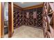 Custom wine cellar with extensive wooden bottle racks, tile flooring, and shelving for showcasing wine collections at 11761 Darsley Dr, Fishers, IN 46037