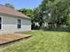 Spacious backyard featuring a wooden deck, green grass, and a classic wooden fence at 12307 Chiseled Stone Dr, Fishers, IN 46037