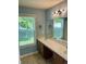 Bathroom with double sinks, a large mirror, and an updated light fixture at 12307 Chiseled Stone Dr, Fishers, IN 46037