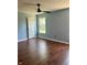 Clean bedroom with wood flooring, a ceiling fan, and a window offering natural light at 12307 Chiseled Stone Dr, Fishers, IN 46037