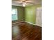 A bright bedroom featuring hardwood floors, window, fan, and closet door at 12307 Chiseled Stone Dr, Fishers, IN 46037