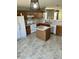 Cozy kitchen with an island, wood cabinets, and a white range and dishwasher at 12307 Chiseled Stone Dr, Fishers, IN 46037