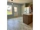 Bright eat-in kitchen with tile flooring, wood cabinets, and a white refrigerator at 12307 Chiseled Stone Dr, Fishers, IN 46037