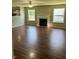 Bright living room with a fireplace, ceiling fan, wood flooring, and multiple windows providing natural light at 12307 Chiseled Stone Dr, Fishers, IN 46037