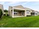 Well-maintained backyard with a covered patio, green lawn, and mature landscaping at 12820 Gloria Dr, Fishers, IN 46037