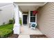 Inviting front porch with a white chair and hanging flowers, offering a cozy and charming entrance at 12820 Gloria Dr, Fishers, IN 46037