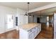 Open concept kitchen with a spacious island, modern lighting, and elegant granite countertops at 12820 Gloria Dr, Fishers, IN 46037