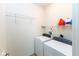 Bright laundry room featuring a washer, dryer, and wire shelving for organized storage at 12820 Gloria Dr, Fishers, IN 46037