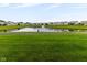 Beautiful pond view with a fountain, surrounded by well-manicured lawns and charming homes at 12820 Gloria Dr, Fishers, IN 46037