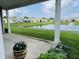 Relaxing pond view from the covered patio, featuring lush greenery and a water fountain at 12820 Gloria Dr, Fishers, IN 46037