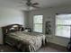 Simple bedroom with ceiling fan and natural light from two windows at 1294 Kenwood Dr, Greenwood, IN 46143