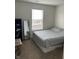 A simply furnished bedroom with carpet and a small window for natural light at 1294 Kenwood Dr, Greenwood, IN 46143