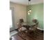 Charming dining area with stylish pendant lighting, a glass-top table, and decorative chairs at 1294 Kenwood Dr, Greenwood, IN 46143