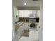 A functional kitchen featuring white appliances, ample counter space, and neutral backsplash at 1294 Kenwood Dr, Greenwood, IN 46143