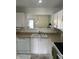 Bright kitchen with white cabinets, laminate countertops, and a functional layout at 1294 Kenwood Dr, Greenwood, IN 46143