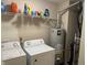 Functional laundry room with washer, dryer, water heater, and storage shelf at 1294 Kenwood Dr, Greenwood, IN 46143