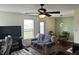 Cozy living room with ceiling fan, comfortable seating, and backyard view at 1294 Kenwood Dr, Greenwood, IN 46143