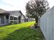 Spacious backyard with green grass and a white wooden fence at 1311 Aaron Dr, Shelbyville, IN 46176