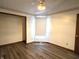 Bedroom featuring wood look floors and white walls with decorative trim at 1311 Aaron Dr, Shelbyville, IN 46176