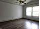 A spacious bedroom with a ceiling fan and a bright window with wood trim at 1311 Aaron Dr, Shelbyville, IN 46176