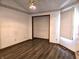 Empty bedroom featuring wood look floors and white walls with decorative trim at 1311 Aaron Dr, Shelbyville, IN 46176