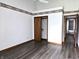 Bedroom featuring wood look floors, closet and white walls with decorative trim at 1311 Aaron Dr, Shelbyville, IN 46176