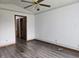 The bright bedroom includes a ceiling fan and wood-look laminate flooring at 1311 Aaron Dr, Shelbyville, IN 46176