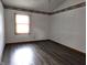 Bedroom featuring wood look floors and white walls with decorative trim at 1311 Aaron Dr, Shelbyville, IN 46176