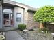 Close up of the front door with decorative glass and lovely landscaping at 1311 Aaron Dr, Shelbyville, IN 46176