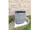 Close-up of a home HVAC unit and stone landscape near brick exterior at 1311 Aaron Dr, Shelbyville, IN 46176
