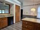 Kitchen with laminate countertops, wood cabinetry, an oven, and hardwood-style flooring at 1311 Aaron Dr, Shelbyville, IN 46176