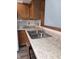 The kitchen boasts laminate countertops, stainless steel sink, and wood-look cabinetry at 1311 Aaron Dr, Shelbyville, IN 46176